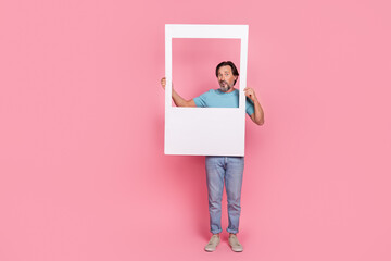 Full body portrait of puzzled person hold paper album set card isolated on pink color background