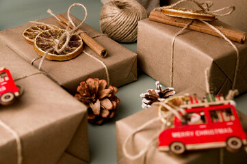 Wrapped presents decorated with wooden toys and dry oranges