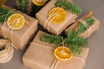 Christmas zero waste concept. Eco friendly packaging gifts in craft paper decorated with dry...