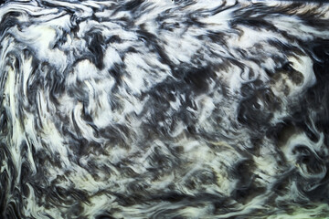 Ink abstract background, black and white pattern of paint under water, acrylic pigment stains, splashes and streaks