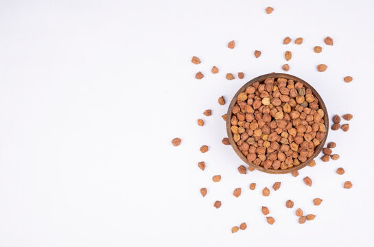 chickpeas (Bengal Gram) in rock bowl on white background. Close up of Organic chana or chickpea (Cicer arietinum). for design and banner. top view chickpeas.