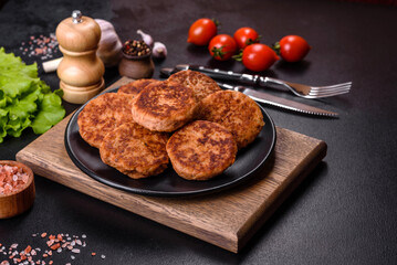 Meatballs with tomato sauce and herbs on the black plate