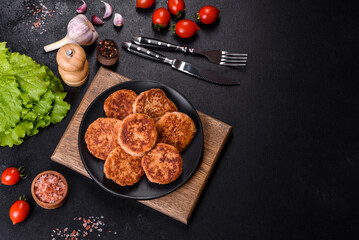 Meatballs with tomato sauce and herbs on the black plate