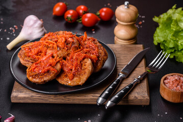 Meatballs with tomato sauce and herbs on the black plate