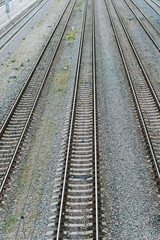 Fototapeta na wymiar Empty railroad, iron rails and sleepers outdoors. Top view, perspective, vertical frame