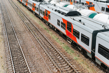 Obraz premium Top view passenger and freight trains on rails outdoors, copy space