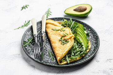 Omelet and Salad with green vegetables avocado and arugula, Delicious vegan, vegetarian breakfast