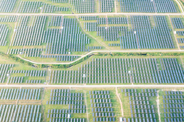 Solar farm, field or solar power plant in aerial view consist of photovoltaic cell in panel, landscape, technology. Industry for electric, electricity generation. Clean green power energy from nature.