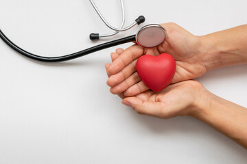 woman hands with red heart and stethoscope