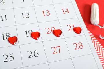 Red hearts on the calendar. A medication plan, schedule, list, or calendar concept.