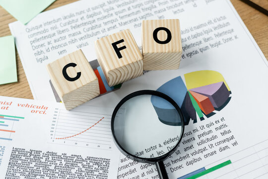 top view of magnifier on charts near cubes with cfo lettering.