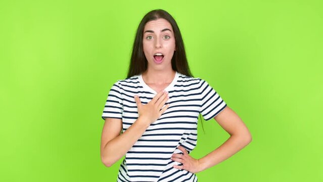 Young brunette woman gaping because have just surprised with a gift over isolated background. Green screen chroma key