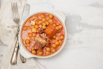 chick pea with smoked sausages in white bowl