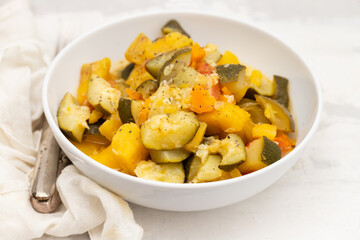 baked vegetables in big white bowl on ceramic