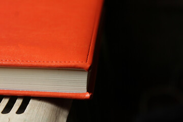 red notebook on a black background