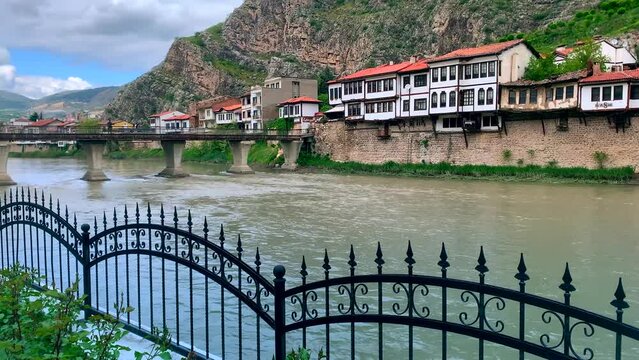 Amasya,TURKEY old riverside Turkish(ottoman) city buildings and its reflection on water,sunny summer day.Old Buildings near the river,bridge. Ottoman Princes were educated in Amasya.