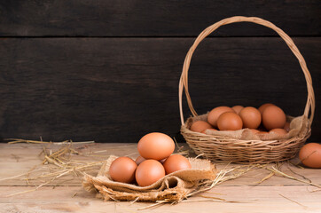 Fresh organic chicken eggs from the farm on a rustic wooden table.