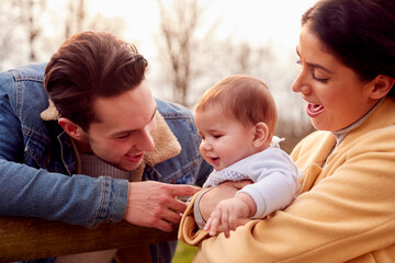 Transgender Family With Baby Enjoying Walk In Autumn Or Winter Countryside