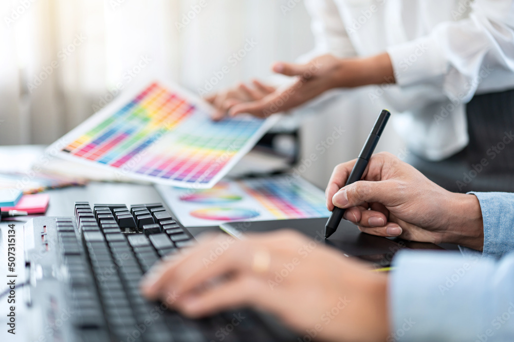 Aufkleber Two creative graphic designer team working on color selection and drawing on graphic tablet, Color swatch samples chart for selection coloring in inspiration to creativity at workplace