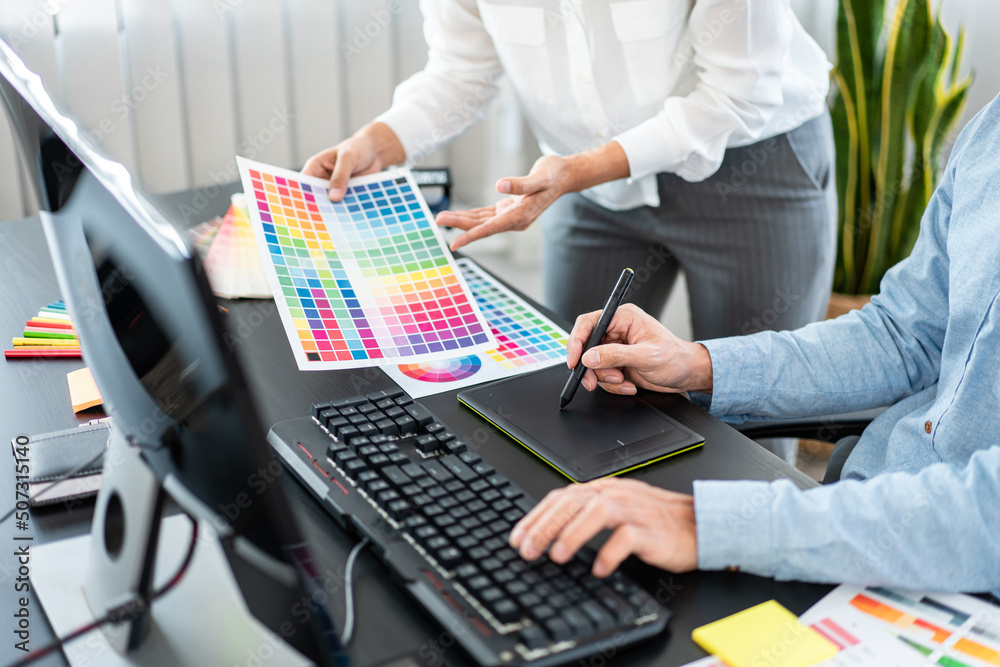 Poster Team of creative graphic designer working on color swatch samples chart for selection coloring in inspiration to create new collection at workplace