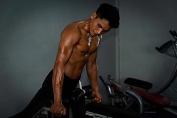 Fototapeta na wymiar Fitness man exercise training warm up body and posing in gym,Healthy lifestyle.