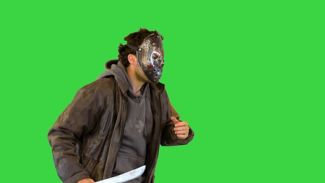 Chasing victim: scary maniac run after scared person Serial killer with knife in mask want to kill on a Green Screen, Chroma Key.