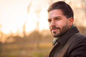 Head And Shoulders Portrait Of Man On Walk Through Autumn Or Winter Countryside