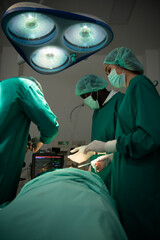 Professor of medicine in cardiology and a team of doctors in the operating room undergoing heart transplant surgery