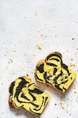 Unusual pumpkin marbled (tiger print) bread with cuttlefish ink, braided on a light background. Useful home baking, copy space.