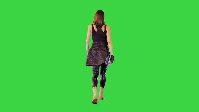 Game-character girl in black military clothes walks on a Green Screen, Chroma Key.