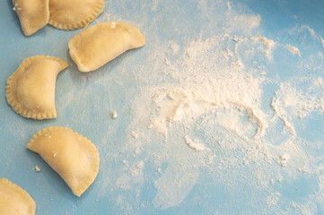 Dumplings on a blue kitchen board