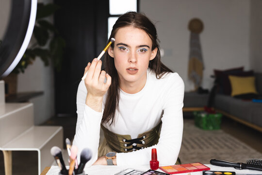 Portrait of non-binary trans woman beauty make up artist vlogger recording makeup tutorial