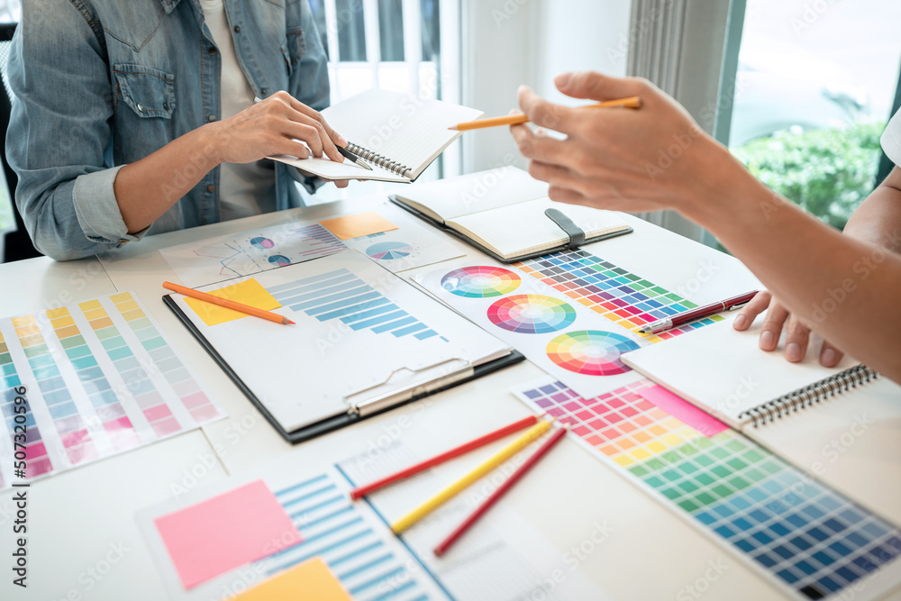 Poster two creative graphic designer team working on color selection and drawing on graphic tablet, color s