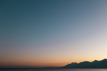 Sea and mountains at sunset