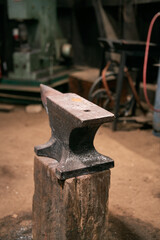 Close up of an anvil in an old blacksmith workshop. Concept of hardworking craftsmanship.