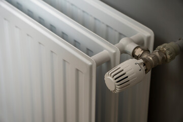 Water radiator close up. Radiator, room interior, grey wall. Interior detail. Home gas heater closeup.