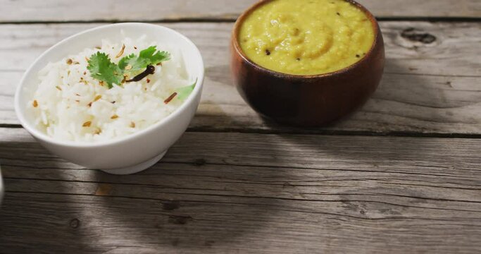 Video of bowls with diverse dips lying in row on wooden surface