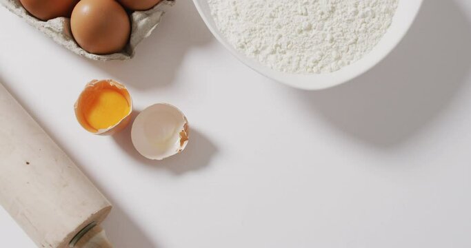 Video of baking ingredients and tools lying on white surface