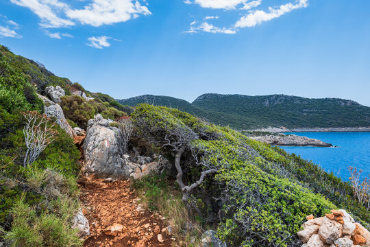 Lycian way hiking and trekking route with sea view  in Turkish Mediterranean area with rocks, mountains. Mountain landscape image taken on the Lycian way hiking trail near Kas, Turkey. 