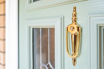 Shallow focus of an ornate door knocker with integrated peep hole. Seen on a newly installed...