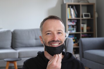 Person pulling down face mask