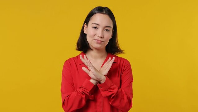 Confident bright sad young woman of Asian ethnicity 20s wears red shirt look camera point fingers herself ask say who me no thanks i do not need it isolated on plain yellow background studio portrait