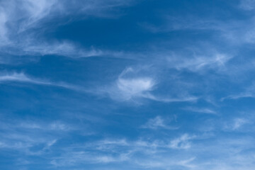 fluffy cirrus clouds in the blue sky