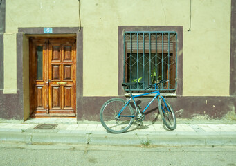 Fototapeta na wymiar long shot of an old bicycle parked in front of a nice village house