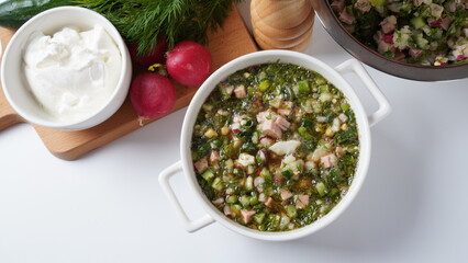 Okroshka, Summer light cold soup with cucumber, radish, eggs and dill with sour cream  and green onion