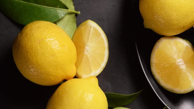 Raw fresh lemons on dark background. Harvest, agricultural concept, healthy organic ingredients
