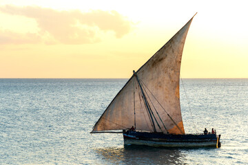 large african sailing dhow on the ocean with a distant blue horizon