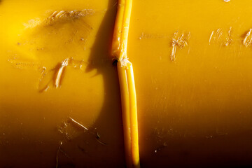 texture of a yellow plastic surface, burnt and distorted