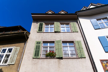 Medieval old town of City of Basel with beautiful historic houses on a blue cloudy spring day. Photo taken April 27th, 2022, Basel, Switzerland.