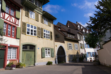 Fototapeta premium Medieval old town of City of Basel with beautiful historic houses on a blue cloudy spring day. Photo taken April 27th, 2022, Basel, Switzerland.